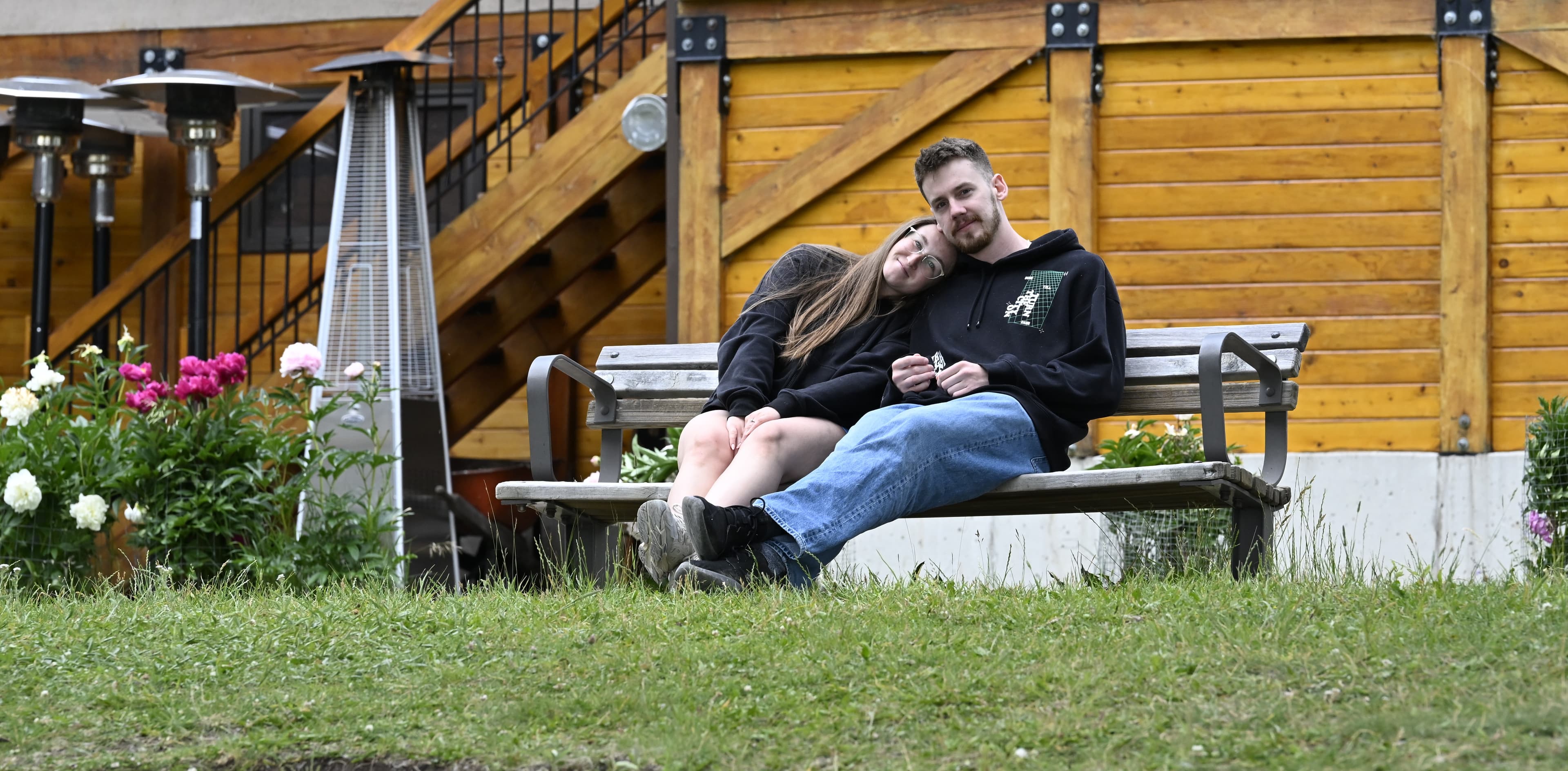 Carly and Brandon seated together outdoors at Knottingwood